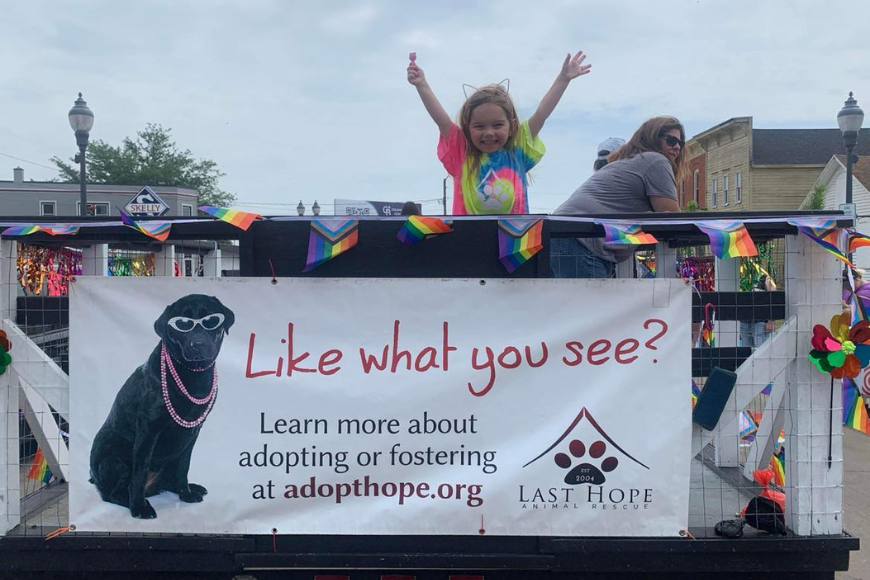 Girl waves on Last Hope Animal Rescue float.